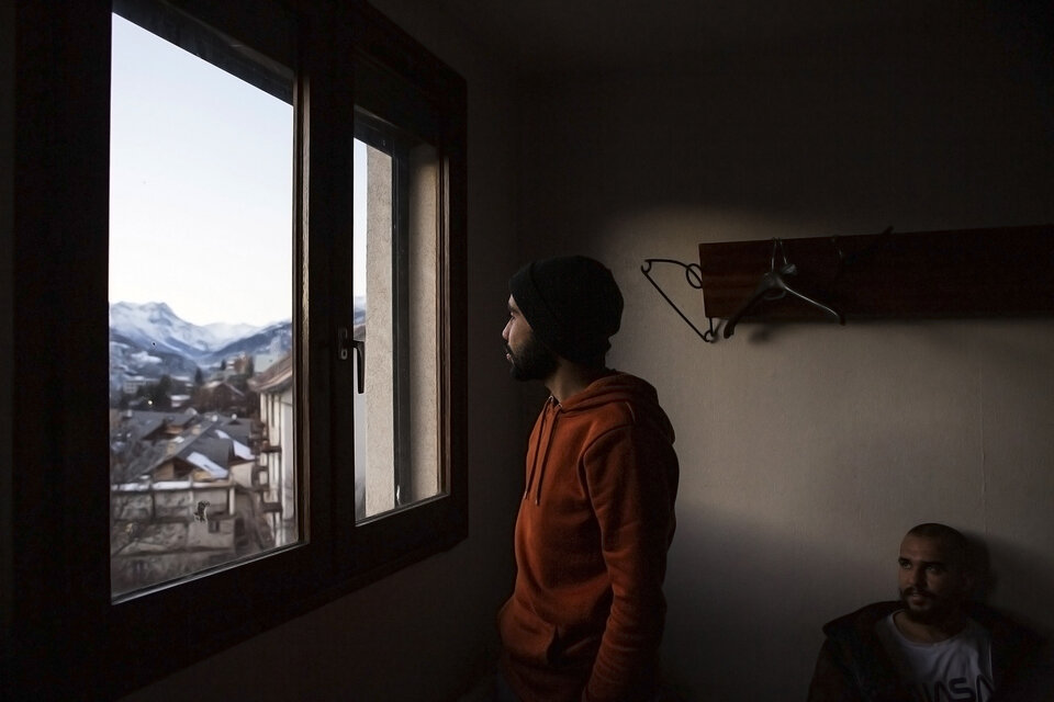 un homme regarde par la fenêtre
